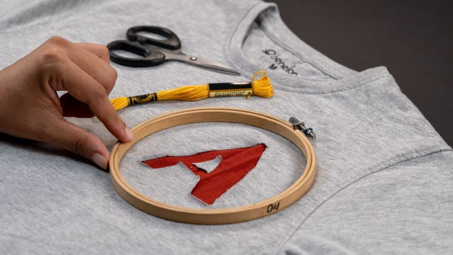 A monogram being embroidered inside a hoop
