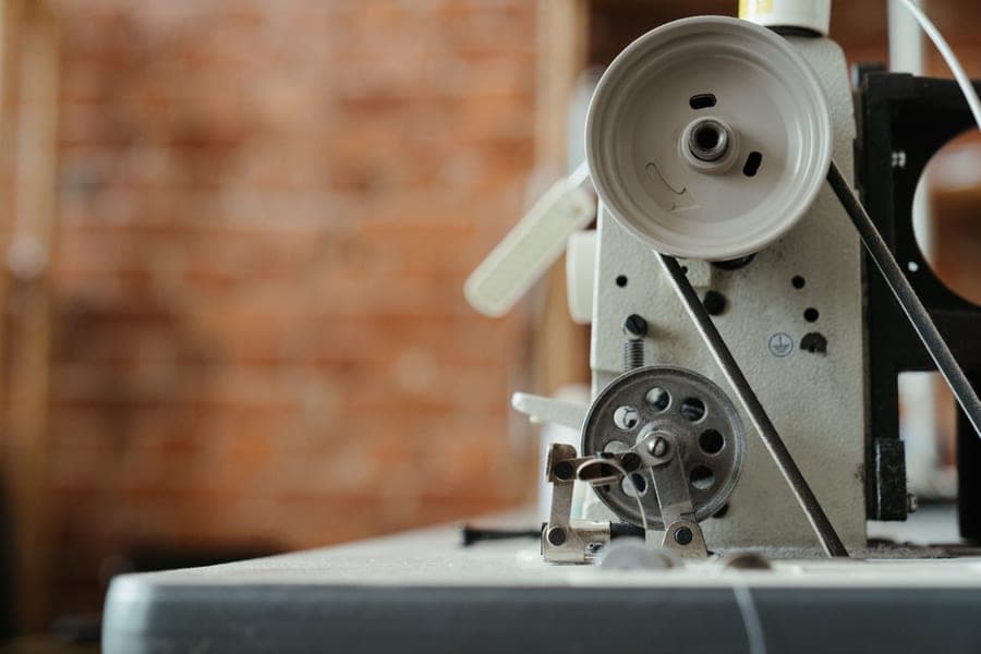 The hand wheel and dials of a mechanical sewing machine