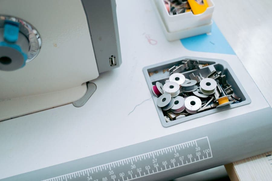 A bobbin being wound with thread on a sewing machine