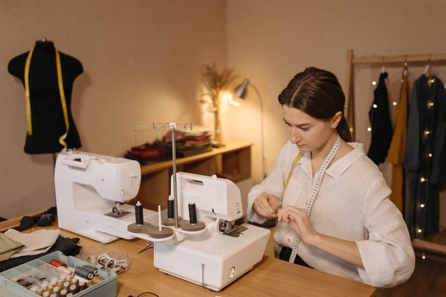A compact sewing machine set up on a small desk