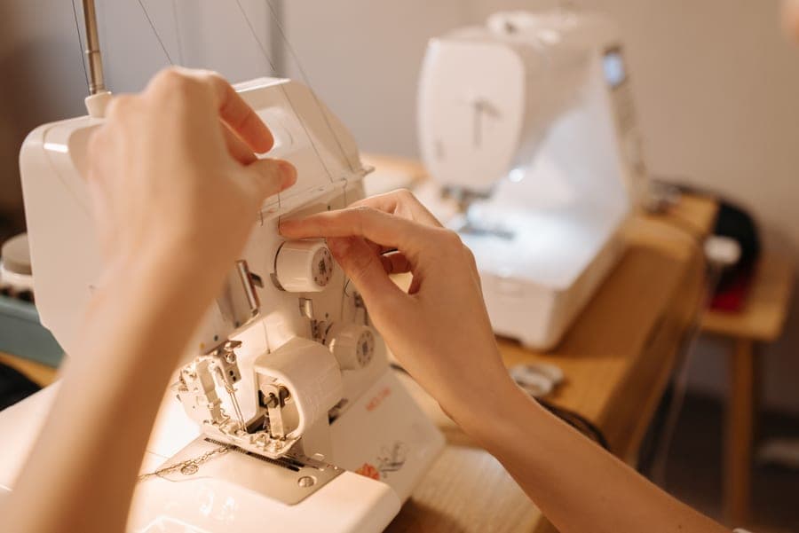 The tension dial on a sewing machine, adjusted by hand